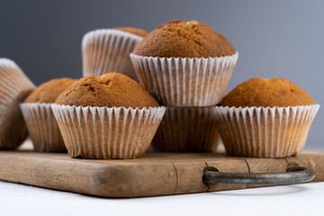 Biscuit muffins close-up. Sweet pastries. Party treat. Dessert on white table - homemade muffins. Portioned cupcakes. Simple muffin