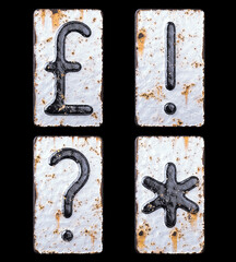 Set of symbols pound, exclamation point, question mark, asterisk made of forged metal on the background fragment of a metal surface with cracked rust.