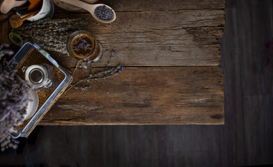 Food background in low key top view. Dark and Moody. Wooden table with a bouquet of lavender, a cup of coffee. Aromatherapy. Place for your text. A branch of dead lavender.
