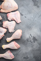 Raw uncooked chicken legs, drumsticks, on gray stone background, top view flat lay, with copy space for text