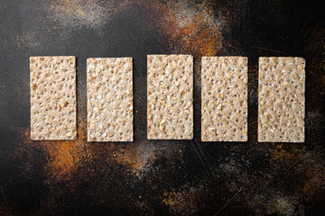 Grain diet light crisp bread , on old dark rustic table background, top view flat lay, with copy...