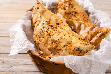 Traditional Chilean empanadas on wooden table