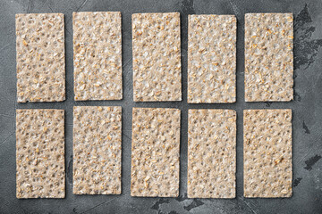 Set of crispy breads, on gray stone table background, top view flat lay, with copy space for text