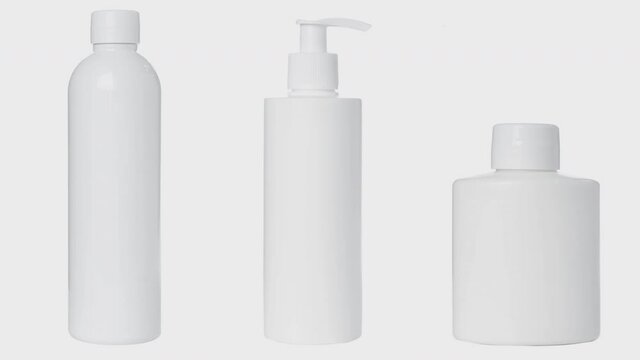 4K video, empty white plastic bottles for cosmetics, cream, lotion, serum, medication on white background.
