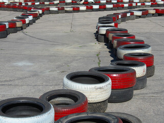 of old black, red and white tires. The trajectory is set. Motion concept. Abstract set with road.