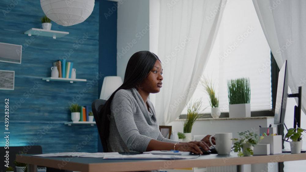 Aufkleber student with black skin browsing high school university information using computer sitting at desk i