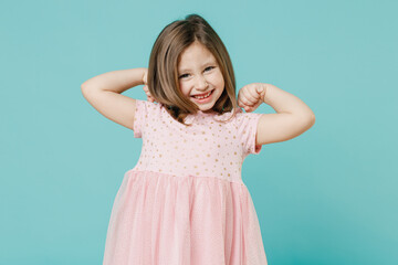 Little toothy smiling cheery cute kid girl 5-6 years old wears pink dress have fun isolated on blue...