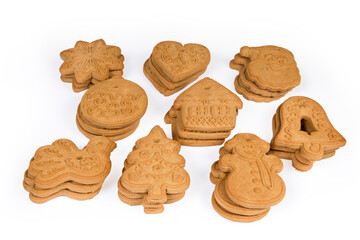 Cookies of various form laid with stacks on white surface