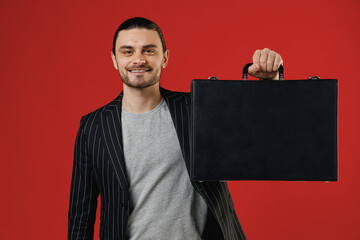 Young smiling successful businessman latin man 20s with ponytail wearing black striped jacket grey...