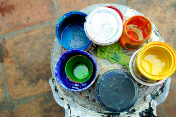 Used paint cans of different colors