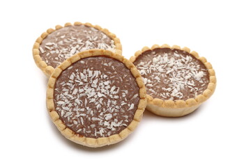 Mini chocolate tarts with coconut filling and shavings isolated on white background