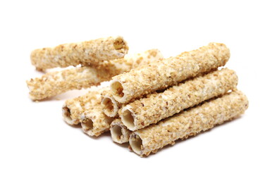 Waffle rolls with chocolate filling in peanut glaze isolated on white background