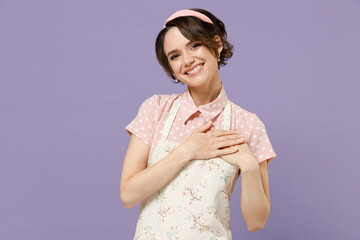 Young fun thankful kind-hearted housewife housekeeper chef cook baker woman wear pink apron put...