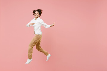 Fototapeta na wymiar Full length young successful employee business woman corporate lawyer in classic formal white shirt work in office jump high point index finger aside on workspace isolated on pastel pink background