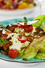 Baked eggplant with cheese. Close-up of a mix of baked eggplant vegetables and delicate ricotta cheese.