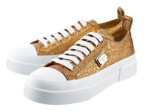  Fashionable dolce gabbana sneakers made of gold-colored fabric, with a logo, on a white sole, isolated on a white background. Belarus, Minsk, 02.06.2021.