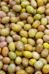 Scratched green olives. Close up. Green olives as background texture