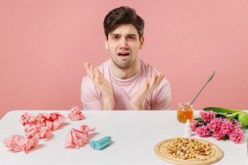 Sick ill allergic man has red watery eyes runny stuffy sore nose suffer from allergy trigger...