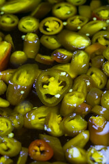 Jalapeno pickled peppers. close up. Pickled peppers as background texture