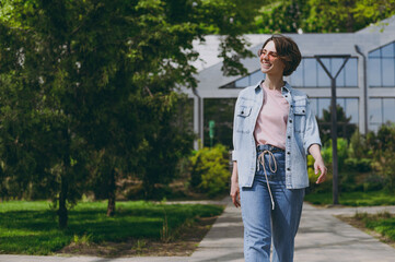 Young fun smiling happy student caucasian woman 20s wear casual trendy jeans clothes pink stylish...