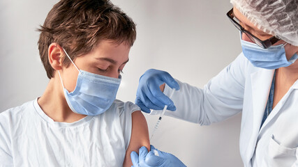 Vaccination of teenagers. Coronavirus, flu or measles vaccine concept. Medic, doctor or nurse with...