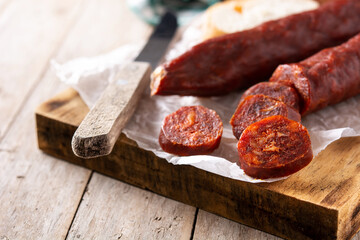 Spanish chorizo sausage on rustic wooden table	