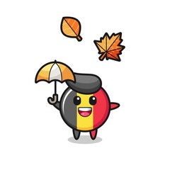 cartoon of the cute belgium flag badge holding an umbrella in autumn