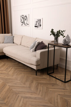 Modern living room with parquet flooring and stylish furniture