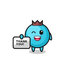 the mascot of the blueberry holding a banner that says thank you