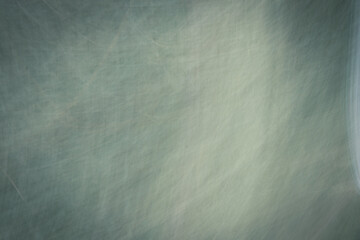 Gray-blue abstract background with highlights and scratches.