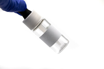 Hand holding a dropper bottle with  blank label isolated white background.