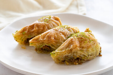 Turkish Dessert Sobiyet Baklava. Turkish pistachio baklava on a white background. Local name şöbiyet baklava