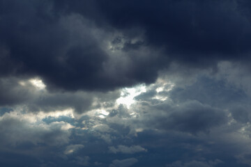 Obraz premium Dark clouds before rain . Dramatic stormy sky light beam . Meteorology background