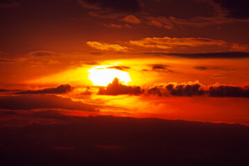 Vibrant red sky with sunset and dark clouds . Fantastic twilight