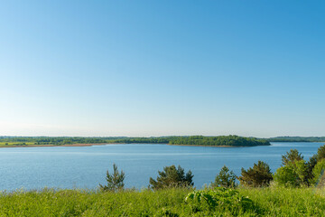 Naklejka na ściany i meble Beautiful view from the cliff to the lake and forest on a bright sunny summer day, Belarus