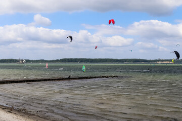 Lots of kite surfing activity at the Baltic Sea beach of Laboe in Germany on a sunny day.