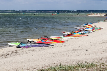 Lots of kite surfing activity at the Baltic Sea beach of Laboe in Germany on a sunny day.