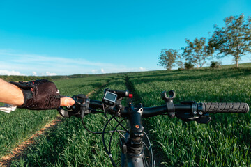 back view of a man with a bicycle against the blue sky. cyclist rides a bicycle.