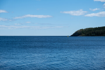 Naklejka premium Island in the blue sea and sky