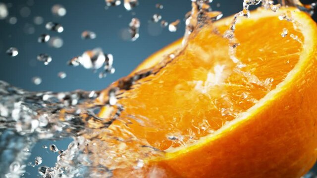 Super slow motion of orange slice with water splashing around. Filmed on high speed cinema camera, 1000 fps.