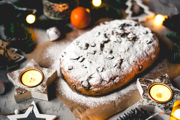 Traditional german stollen cake with Christmas decorations on the table.