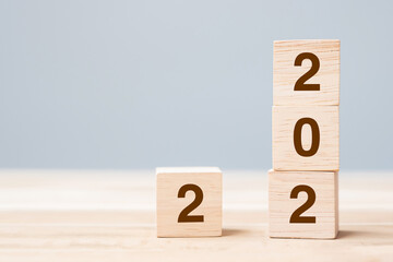2022 wooden cube blocks on table background. Resolution, plan, review, goal, start and New Year...