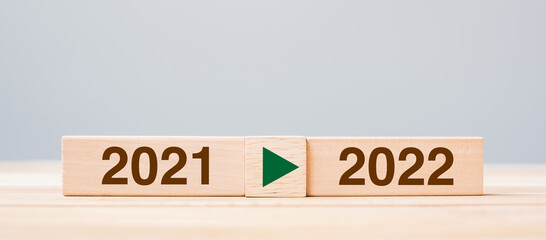 2021 and 2022 wooden block on table background. Resolution, strategy, countdown, goal, change and...