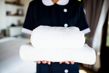 Housekeeper handing a new set of towels