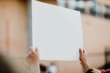 Man holding a blank white board at a black lives matter protest