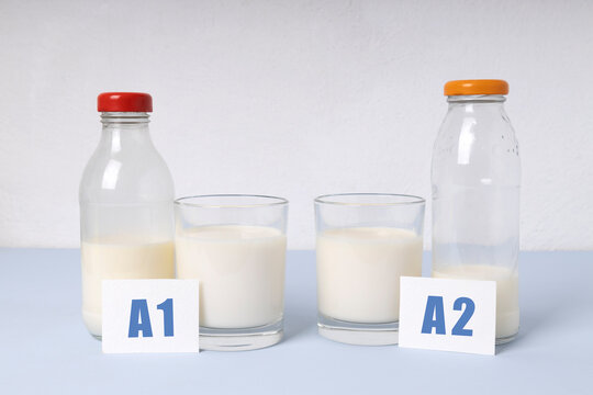 Two Bottles And Glass Of Milk Different Types.A1 And A2 Milk Variety