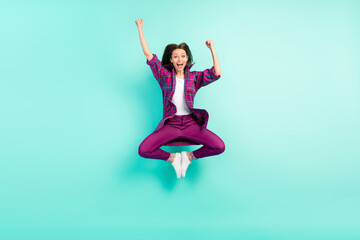 Full length body size view of attractive cheerful girl jumping rejoicing having fun isolated over bright teal color background