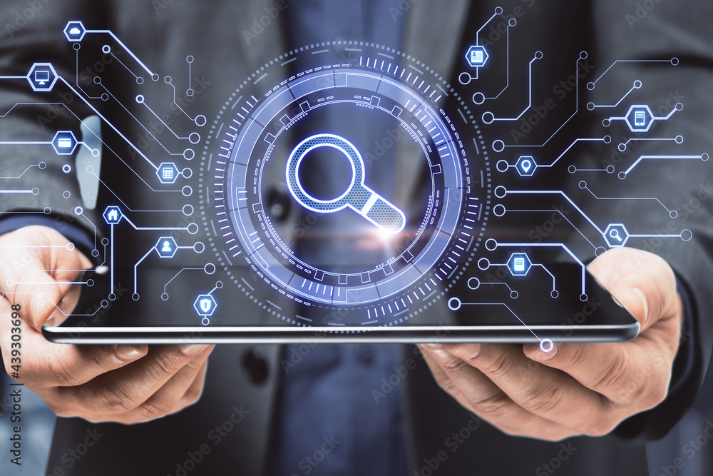 Poster Searching information data on internet concept with businessman holding digital tablet and virtual magnifier in technological circuit.