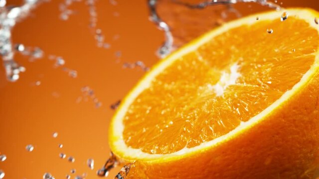 Super slow motion of orange slice with water splashing around. Filmed on high speed cinema camera, 1000 fps.