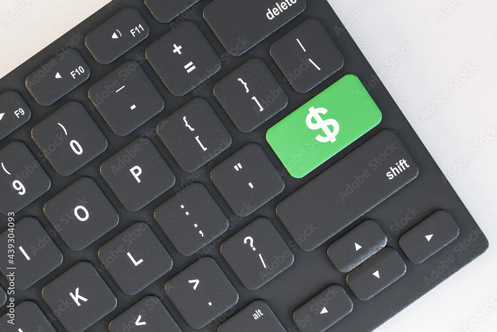 Aufkleber Top view and close up of computer keyboard with green dollar button on desktop. Cryptocurrency concept. 3D Rendering.